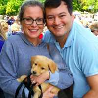 <p>Tracee and Michael Sherman with puppy Cooper.</p>