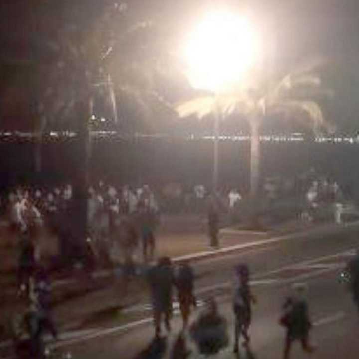 Bastille Day revelers in Nice, France run for cover after a truck rammed through the crowd Wednesday.