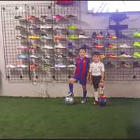 <p>The Vazquez&#x27; nephews, from left, Ricardo and Bryan Rodriguez, stand beside shoes in the store.</p>