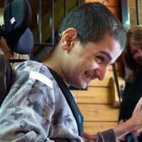 <p>A young boy with special needs pets a horse at Pony Power in Mahwah.</p>