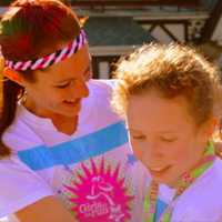 <p>Ramsey Girls on the Run coach Maggie Ford embraces an athlete following the May 5K race in Sparta.</p>