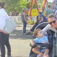 <p>Julie Gurney with her 15-month old son Dean. Gurney&#x27;s 7-year-old twins John and Allan are having fun on the carnival rides.</p>