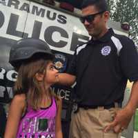 <p>Gianna, 9, gets fitted for a police helmet at National Night Out in Paramus.</p>