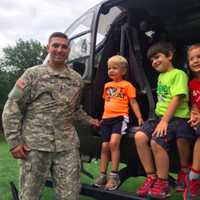 <p>Paramus Police Officer Matt Lombardo shows youngsters the inside of his ride — a helicopter.</p>