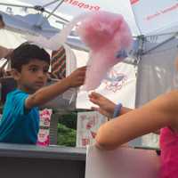 <p>A young volunteer distributes cotton candy.</p>