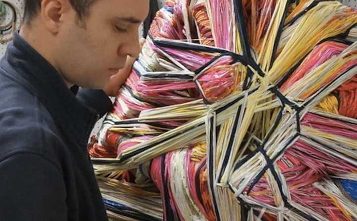 Ruben Marroquin works on a piece of fiber art.