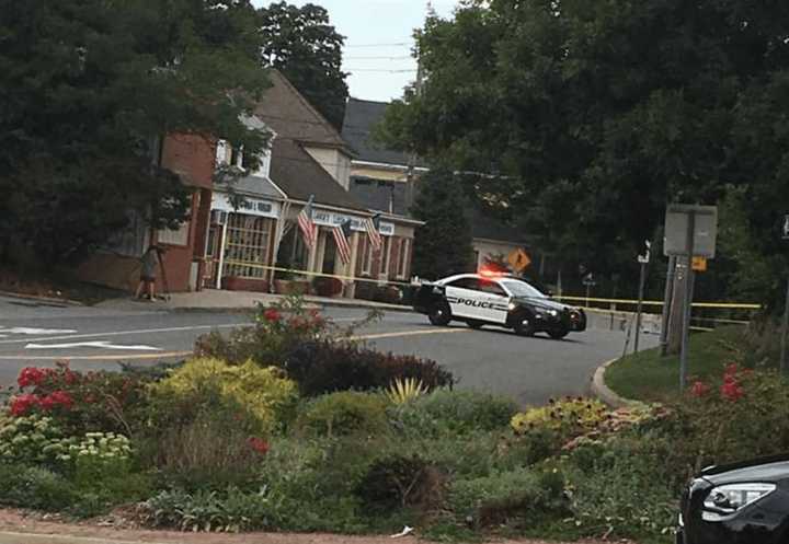 A New Castle Police car is pictured next to Lange&#x27;s, a popular deli in Chappaqua, following a shooting on Monday morning.