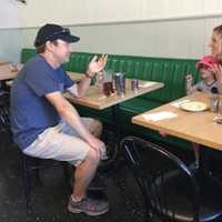 <p>U.S. Sen. Chris Murphy speaks with Fairfield resident Abigail Lorge and her daughter Eliza at the Driftwood Café in Southport during last year&#x27;s walk across Connecticut.</p>