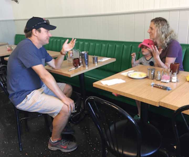 U.S. Sen. Chris Murphy speaks with Fairfield resident Abigail Lorge and her daughter Eliza at the Driftwood Café in Southport on Friday.