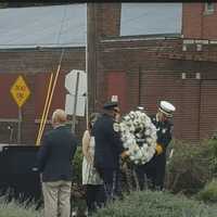 <p>Danbury Fire Chief TJ Wiedl and Danbury Police Chief Patrick Ridenhour place the wreath on the Sept. 11 Memorial.</p>