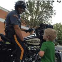 <p>A Paramus police officer talks to Robert, 3, before the Freedom Walk.</p>