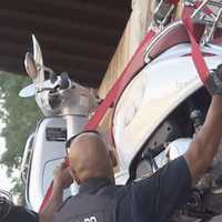 <p>Hastings-on-Hudson police hoist a motorized scooter off the railroad tracks on Thursday morning.</p>