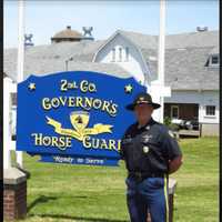 <p>2nd Lt. Fay standing at the sign for the Second Company Governor&#x27;s Horse Guard at their home in Newtown.</p>