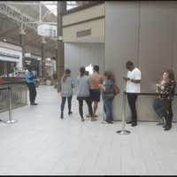 <p>People wait in line on Friday afternoon to purchase an iPhone 7 at the Apple store at the Danbury mall.</p>