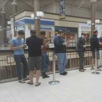 <p>People wait in a long line to purchase their pre-ordered iPhone 7 phone at the Apple store at the Danbury mall.</p>