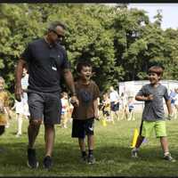 <p>John Devlin joins his son, Luke, and friend Oliver Vigale for a lap.</p>