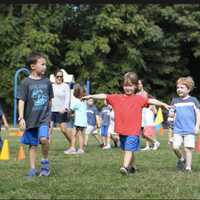 <p>Kindergartners Kyle Cheng, Dylan Danile and Jack McKay take part in their first walkathon.</p>