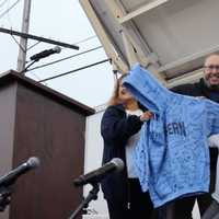 <p>Suffern Middle School vice principal Danielle Castaldo and principal Brian Fox present Grace Vanderwaal with a sweatshirt signed by all of her seventh grade classmates.</p>