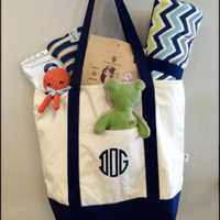 <p>A selection of treats and a DOG monogrammed tote bag filled with essentials for traveling with a dog.</p>