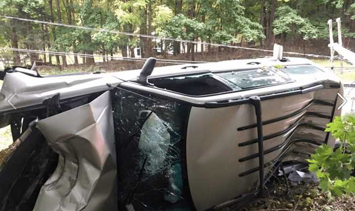 The driver of the overturned vehicle escaped with minor injuries, police said.