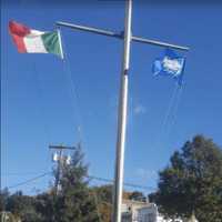 <p>The Italian flag going up in honor of Columbus Day on Monday in Bethel</p>