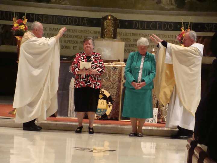 Blauvelt Dominican Sisters Carol Carullo, left, and Dorothy Maxwell, right, renew their vows at their Golden Jubilee Liturgy.