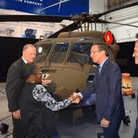 <p>Gov. Dannel Malloy congratulates a worker at Sikorsky Aircraft in Stratford as the helicopter manufacturer delivers the 1,000th Black Hawk to the U.S. Army.</p>