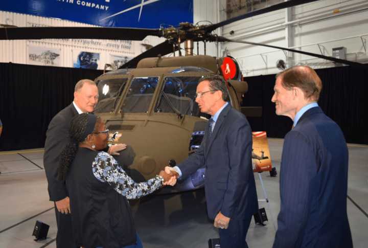 Gov. Dannel Malloy congratulates a worker at Sikorsky Aircraft in Stratford as the helicopter manufacturer delivers the 1,000th Black Hawk to the U.S. Army.