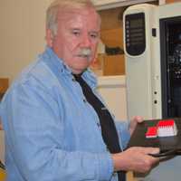 <p>Jim Barber demonstrating his three-dimensional printer</p>