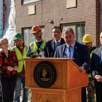 <p>Yonkers Mayor Mike Spano with some of the nearly 100 construction workers at the topping off ceremony for the River of Tides at Greystone luxury apartment building.</p>