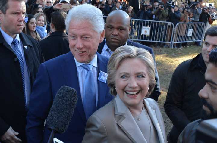 Hillary and Bill Clinton walk by supporters and reporters in front of Douglas G. Grafflin Elementary School in Chappaqua after casting their presidential votes.