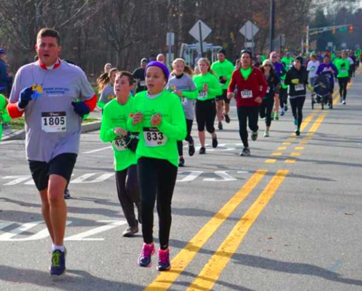 Chris and Caitlyn Kunisch Caitlyn lead the trotters down the home stretch of the annual Upper Saddle River 5K.