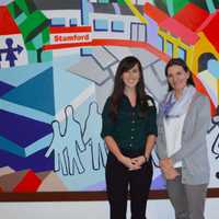 <p>From left, Christa Chu, development and communications manager; and Catalina Horak, executive director of Neighbors Link Stamford.  They are standing in front of a mural created by a Mexican immigrant with help from over 200 volunteers.</p>