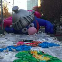 <p>Super Grover slowly rises as it is inflated Saturday.</p>