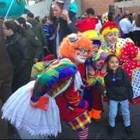 <p>A child poses with clowns at the balloon inflation party Saturday for the UBS Parade Spectacular.</p>