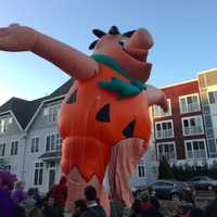 <p>The Fred Flintstone balloon is one of the first balloons inflated Saturday before the UBS Parade Spectacular on Sunday.</p>