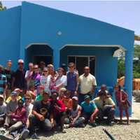 <p>The family, the volunteer group from the United States and some of the volunteers from community pose in front of the finished house.  The team took just five days to complete the home from the foundation up.</p>