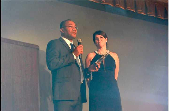 Danbury resident Rebecca Tate receiving an award on behalf of Cambiando Vidas at the Dominican Club in Danbury