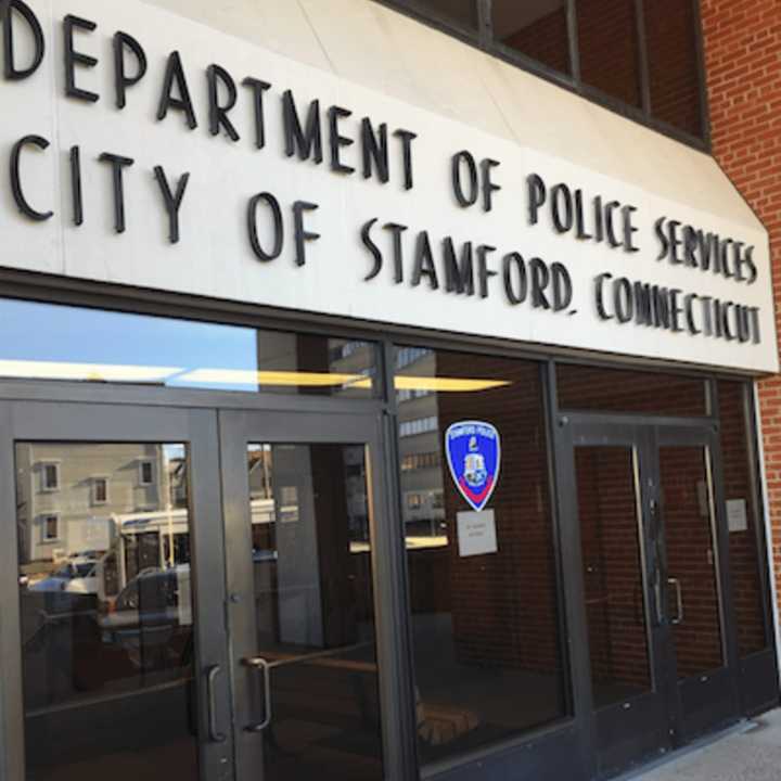 Stamford Police arrest two brothers after violent dispute with neighbor that began with a text to the man&#x27;s girlfriend.