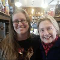 <p>Hillary Clinton at The Savoy Bookstore in Waverly, Rhode Island, on Sunday with store employee Jessica Wick.</p>