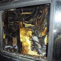 <p>The fire-damaged interior of a Range Rover in which a Wilton man was pulled from by Wilton Police officers before fire engulfed it.</p>