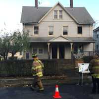 <p>At least six people were displaced due to a fire Friday afternoon at 38-40 Lockwood Ave. A couple of the residents, including a man in a wheelchair, can be seen in background under the street signs.</p>