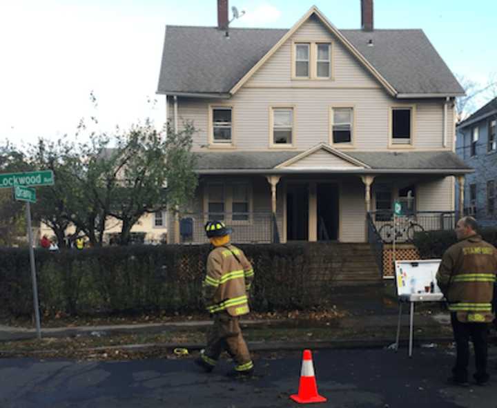 At least six people were displaced due to a fire Friday afternoon at 38-40 Lockwood Ave. A couple of the residents, including a man in a wheelchair, can be seen in background under the street signs.