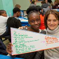 <p>Ninth-grader Agyeiwa Okodie and her graduation coach, Susan Roth, hold a banner showing the student&#x27;s goals at a recent Yonkers Partners in Education event celebrating incoming program participants.</p>