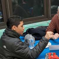 <p>Kevin Matos, a ninth-grader from Saunders High School, chats with his Yonkers Partners in Education graduation coach, Ed Irwin.</p>
