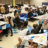 <p>Young scholars hold up their “vision banners” at a recent Yonkers Partners in Education event. The banners detail the students&#x27; goals for both high school and college.</p>