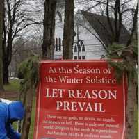 <p>Jerry Bloom put up a banner celebrating the Winter Solstice on the Huntington Green in Shelton. It was recently slashed by vandals and has been taken down.</p>