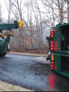 Garbage Truck Rolls Over, Spilling Fuel Near John Jay High School
