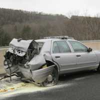 <p>A motorist allegedly slammed into a parked State Police vehicle on Route 7 in Brookfield Monday morning. The driver and trooper were taken to hospital with undetermined injuries.</p>