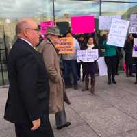 <p>Greenwich RTM member Chris Von Keyserling, in hat, walking with lawyer Phil Russell past protestors following his first court appearance on a sexual assault charge.</p>